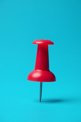 Poster - A business concept is presented using a successful idea of a red pin and thumbtack against a blue background in selective focus._00002_