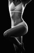 © Dimid - A slender swarthy woman in underwear on a white background. Healthy lifestyle, sport and diet.
