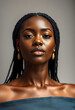 © Go - A stunning close-up portrait of a confident woman with dark skin and braids, wearing gold earrings and displaying natural beauty.