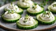 © bird_saranyoo - Light Nordic snack: cucumber slices topped with cream cheese and a sprinkle of herbs