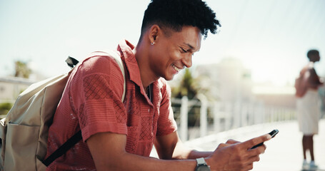Fototapete - Mobile, happy student and man at college outdoor for course schedule, learning and online education. Smile, phone and male person at university campus to check test results, research or typing text