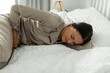 © Home-stock - Period of PMS. Unhappy lady suffering stomach aches from abdominal pain, touching stomach while lying on bed