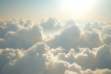 Wall Mural - Aerial view of fluffy white clouds illuminated by sunlight.