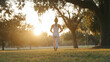 © Tania - Young Woman Stretching in Green Park for Morning Workout