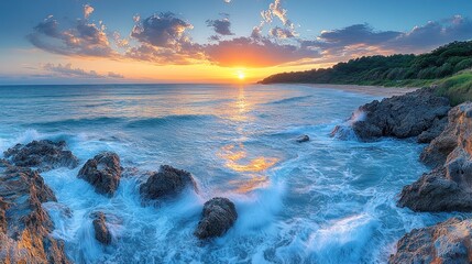 Aufkleber - A serene sunset over a rocky beach with gentle waves and vibrant sky colors.