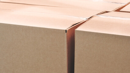 Poster - A stack of cardboard boxes with a white tape on the top. The boxes are brown in color