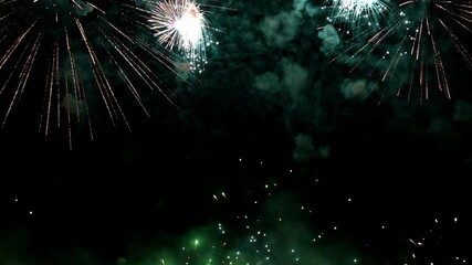 Wall Mural - Bright colorful festive glowing fireworks on night sky.  New Year, Christmas, festival, party and holiday celebration concept