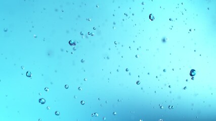 Poster - Super Slow Motion of Flying Water Drops, Isolated on Blue Background. Filmed on High Speed Cinema Camera, 1000fps.