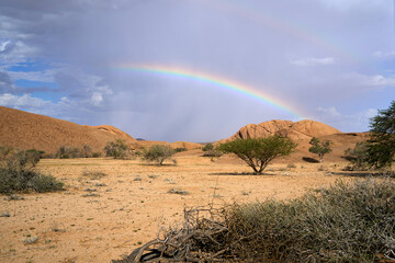 a single rainbow over the rocks at bushman paradise, spitzkoppe, namibia