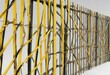 © Phetthanousack - Yellow and black striped construction fence on white background, blocked entrance, construction industry, boundary protection, warning tape, work in progress