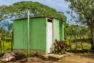 Wall Mural - A green and white building with a door and a window