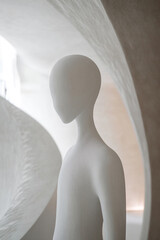 Aufkleber - Sculpture of a simplistic humanoid figure in an abstract architectural space with smooth curves and soft lighting