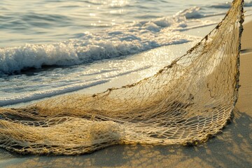 Wall Mural - Old fishing net on sandy beach, waves.