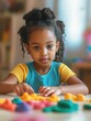 © Johannes - childhood, creativity and hobby concept - little african american girl with modeling clay playing at home