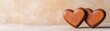 © Preeyanuch - Two wooden hearts placed close together on a textured surface, symbolizing love and affection in a warm, inviting setting.