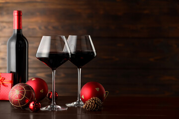 Canvas Print - Red wine and beautiful Christmas decor on wooden table. Space for text