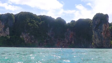 Wall Mural - Go by boat trip limestone cliffs and turquoise waters Thailand.