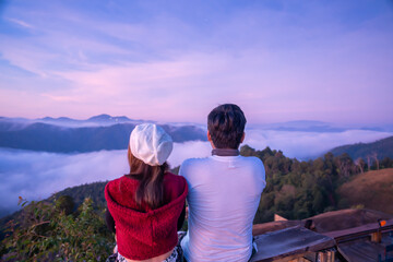 Wall Mural - couple tourist come to hill tribe village guest house to watch stars and sky at night , cloud , sunrise and lake of fog in the morning hay kubkab mae taeng chiangmai thailand  