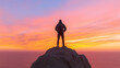 © andrasgyalog - Man on Coastal Peak at Sunset