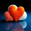 © Rumi - Cozy and Modern Design Featuring a Bright Orange Knitted Heart with a White Embroidered Heart Accent on a Reflective Blue Surface Against a Dark Background