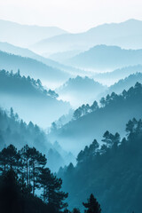 Wall Mural - Majestic mountain landscape with layered peaks shrouded in mist during early morning light