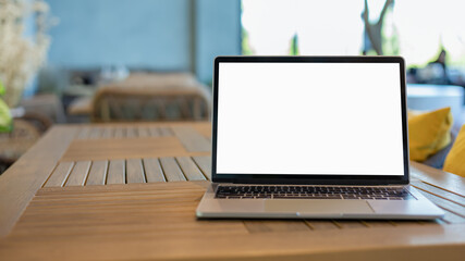 Poster - Workspace background new project on laptop computer with blank copy space screen for your advertising text message. Laptop with blank screen and placed on a wooden table inside a coffee shop.
