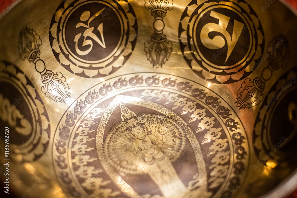 A close-up view of an intricately designed Tibetan singing bowl ...