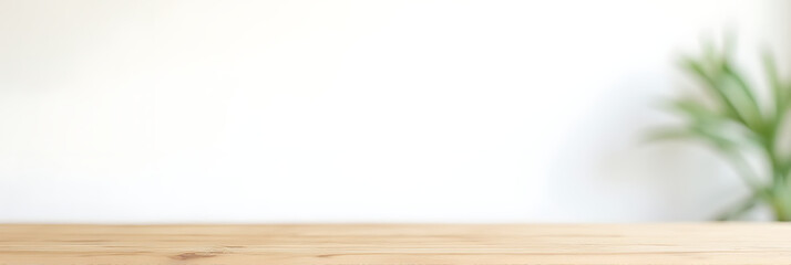 Poster - A wooden table top is placed against a white wall with a subtle leaf pattern in the background._00001_