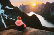 © EVERST - Woman hiking in Lofoten islands travel lifestyle outdoor in Norway, girl traveler in camping chair on Reinebringen mountain top, active vacations adventure sustainable tourism harmony with nature