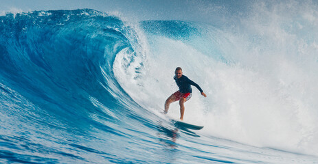 Wall Mural - Pro surfer rides big wave in the Maldives