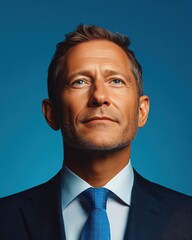 Confident businessman with a suit and a smile in a studio background, He looking at the camera