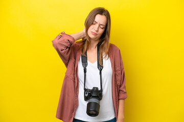 Wall Mural - Young photographer caucasian woman isolated on yellow background with neckache