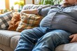 © Aleksandr - Overweight Man Relaxing On Sofa, Concepts Of Obesity, Unhealthy Lifestyle, And Weight Loss