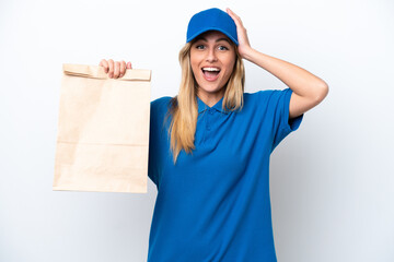 Canvas Print - Young Uruguayan woman taking a bag of takeaway food isolated on white background with surprise expression