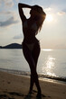 © eugenepartyzan - silhouette of sexy girl on the beach at sunset. young beautiful woman and sea