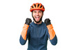 © luismolinero - Young cyclist man over isolated chroma key background celebrating a victory in winner position