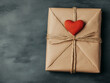 © Kingdola - Heartfelt Gift: A rustic, kraft paper-wrapped gift box tied with twine, adorned with a small red heart. Perfect for Valentine's Day, anniversaries, or expressing love.