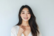© Surachetsh - Portraits of Asian women in simple casual attire, standing against plain white background, wear minimal makeup display natural expressions, emphasizing modern, everyday style.