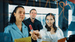 © Summit Art Creations - Portrait of professional diverse business team brainstorming marketing idea on colorful sticky notes stuck on glass board. Hispanic project manager write business strategy on note. Manipulator.