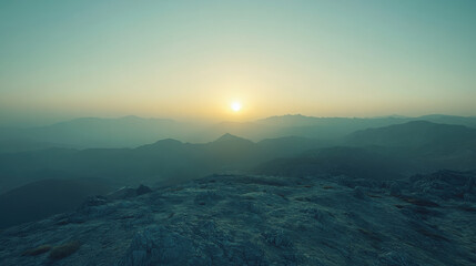 Wall Mural - A serene sunrise over distant mountains, creating a tranquil and atmospheric landscape.