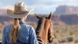© Archibalttttt - Cowgirl riding horse and admiring monument valley landscape