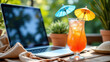 © Tameem - A relaxed summer Fridays scene featuring a laptop on an outdoor table next to a refreshing drink with a straw and a colorful umbrella.