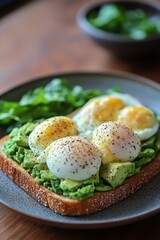 Wall Mural - Delicious avocado toast topped with poached eggs served with fresh greens in a stylish setting