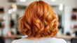 © Kate - Bright orange curls showcase a stylish haircut in a modern salon