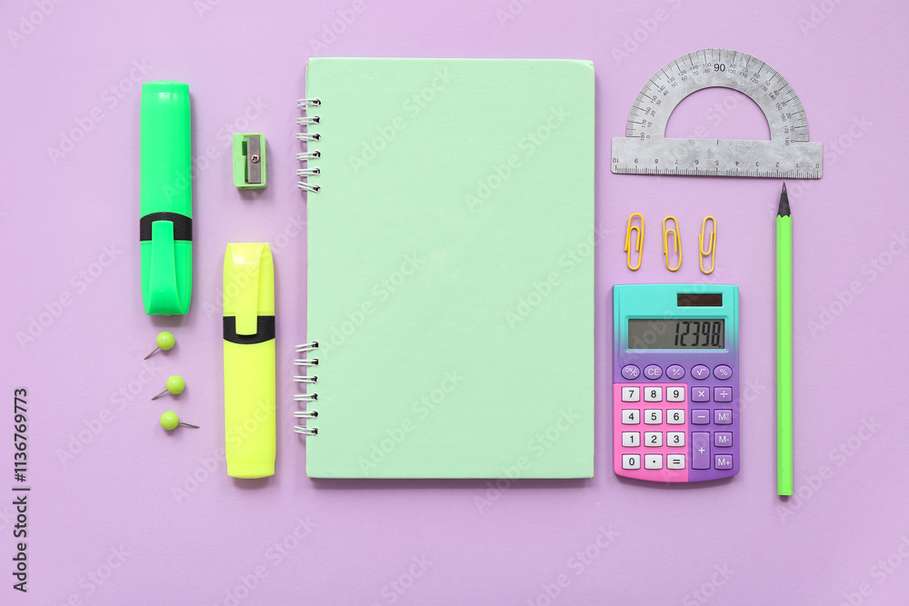 Calculator and school stationery on lilac background