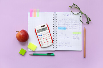 Wall Mural - Notebook with apple, eyeglasses and school stationery on lilac background