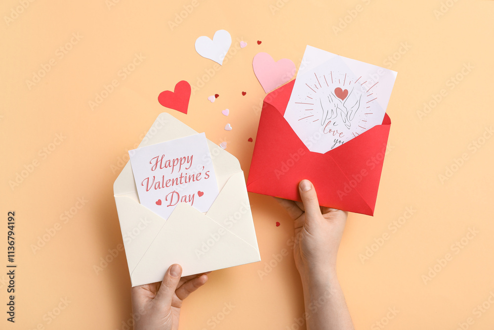 Woman holding envelopes with gift cards on beige background. Valentine's day celebration