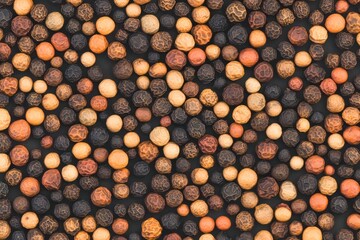 Poster - Beautiful pattern texture of assorted pepper seeds on a dark background showcasing their natural diversity and unique shapes