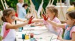 © Konstiantyn Zap - Joyful children painting outdoors with colorful hands at art class