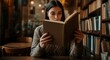 © Konstiantyn Zap - Young caucasian female reading in cozy library setting